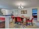 Dining room with wood table, red chairs, and access to other rooms at 1723 N Gondola Ct, Venice, FL 34293