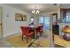 Elegant dining room with a wooden table, red chairs, and access to patio at 1723 N Gondola Ct, Venice, FL 34293