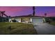 House exterior at dusk showcasing the landscaping and driveway at 1723 N Gondola Ct, Venice, FL 34293
