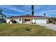 Single story home with attached garage and well-maintained lawn at 1723 N Gondola Ct, Venice, FL 34293