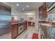 Open kitchen with granite counters, stainless steel appliances, and views to dining area at 1723 N Gondola Ct, Venice, FL 34293