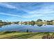 Tranquil lakefront property with reflections of homes under a vibrant sky at 1723 N Gondola Ct, Venice, FL 34293