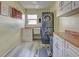 Bright laundry room with stacked washer/dryer and white cabinets at 1723 N Gondola Ct, Venice, FL 34293