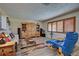 Comfortable living room with wood floors, a blue recliner, and built-ins at 1723 N Gondola Ct, Venice, FL 34293