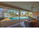 Inviting kidney-shaped pool with screened enclosure and water views at 1723 N Gondola Ct, Venice, FL 34293