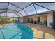 Stunning kidney-shaped pool with screened enclosure and canal views at 1723 N Gondola Ct, Venice, FL 34293
