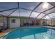 Enjoy this refreshing pool with a screened enclosure and patio access at 1723 N Gondola Ct, Venice, FL 34293