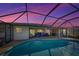 Stunning pool and screened patio at sunset at 1723 N Gondola Ct, Venice, FL 34293