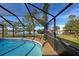 Inviting pool area with screened enclosure and lake view at 1723 N Gondola Ct, Venice, FL 34293