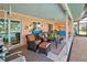 Relaxing screened patio with wicker furniture, overlooking pool and canal at 1723 N Gondola Ct, Venice, FL 34293