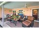 Spacious screened patio furnished with wicker seating and a ceiling fan at 1723 N Gondola Ct, Venice, FL 34293