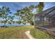 Scenic backyard view of a peaceful lake with lush greenery at 1723 N Gondola Ct, Venice, FL 34293