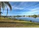 Serene waterfront view with lush lawn, dock, and beautiful homes at 1723 N Gondola Ct, Venice, FL 34293