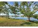 Peaceful waterfront view with lush landscaping and tranquil waters at 1723 N Gondola Ct, Venice, FL 34293