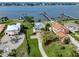 Sprawling waterfront property with manicured lawns, mature trees, and a charming yellow home at 1784 Bayshore Dr, Englewood, FL 34223