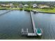 Overhead view of a waterfront property featuring a boat dock and lush greenery at 1784 Bayshore Dr, Englewood, FL 34223