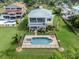 Aerial view of a beautiful backyard with a large pool and lush green lawn at 1784 Bayshore Dr, Englewood, FL 34223
