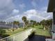 Scenic view from the back porch showcasing a rainbow over the lawn and waterfront at 1784 Bayshore Dr, Englewood, FL 34223