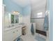 Elegant bathroom with marble countertops, white cabinets, and a glass-enclosed shower with pebble flooring at 1784 Bayshore Dr, Englewood, FL 34223