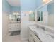Beautiful bathroom with dual sinks, marble countertops, and wainscoting details at 1784 Bayshore Dr, Englewood, FL 34223