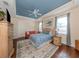 Cozy bedroom featuring a blue ceiling, hardwood floors, and lots of natural light from the windows at 1784 Bayshore Dr, Englewood, FL 34223