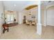 Bright foyer featuring tile flooring, arched doorways, columns, and a formal dining area with elegant chandelier at 1784 Bayshore Dr, Englewood, FL 34223