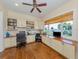 Bright home office with built-in cabinets, hardwood floors, and a large window with a view at 1784 Bayshore Dr, Englewood, FL 34223