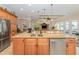 Large kitchen island featuring stainless steel appliances, granite countertops and an open view to the living areas at 1784 Bayshore Dr, Englewood, FL 34223