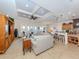 Spacious living room features tile floors, a tray ceiling, comfortable furniture, and access to a waterfront balcony at 1784 Bayshore Dr, Englewood, FL 34223