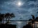 Picturesque waterfront view at night with calm waters and a mesmerizing moonlit sky at 1784 Bayshore Dr, Englewood, FL 34223