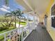 Spacious porch with a view of the lush green landscaping and winding brick driveway at 1784 Bayshore Dr, Englewood, FL 34223