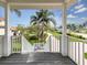 Inviting porch view featuring lush green landscaping and a brick driveway at 1784 Bayshore Dr, Englewood, FL 34223