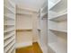 Spacious walk-in closet with custom shelving and hanging rods for organized storage at 1784 Bayshore Dr, Englewood, FL 34223