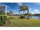 Landscaped backyard with lake view at 19374 Rizzuto St, Venice, FL 34293