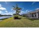 Waterfront backyard oasis with screened patio and tropical landscaping at 19374 Rizzuto St, Venice, FL 34293
