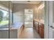 Double vanity bathroom with garden view from shower at 19374 Rizzuto St, Venice, FL 34293