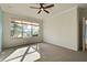 Bedroom with neutral walls, carpet flooring, and a window at 19374 Rizzuto St, Venice, FL 34293