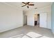 Spacious bedroom with ceiling fan and access to bathroom at 19374 Rizzuto St, Venice, FL 34293