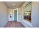 Front entry with teal door, tile floor, and window view at 19374 Rizzuto St, Venice, FL 34293