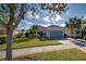 Single-story home with teal garage door and landscaped yard at 19374 Rizzuto St, Venice, FL 34293