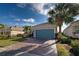 Single-story home with teal garage door and paved driveway at 19374 Rizzuto St, Venice, FL 34293