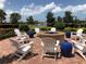 Relaxing fire pit area with chairs and lake views at 19374 Rizzuto St, Venice, FL 34293