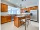 Island kitchen with granite countertops and stainless steel appliances at 19374 Rizzuto St, Venice, FL 34293