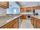 Modern kitchen with stainless steel appliances and granite countertops at 19374 Rizzuto St, Venice, FL 34293