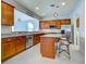 Spacious kitchen with wood cabinets, granite counters, and stainless steel appliances at 19374 Rizzuto St, Venice, FL 34293