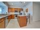 Kitchen with island, wood cabinets, granite counters at 19374 Rizzuto St, Venice, FL 34293