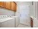Laundry room with washer, dryer, and cabinets at 19374 Rizzuto St, Venice, FL 34293
