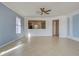 Spacious living room with tile floors and ceiling fan at 19374 Rizzuto St, Venice, FL 34293