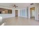 Open living room with tile floors and a view into the kitchen area at 19374 Rizzuto St, Venice, FL 34293