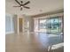 Spacious living room with tile floors, sliding glass doors, and water views at 19374 Rizzuto St, Venice, FL 34293